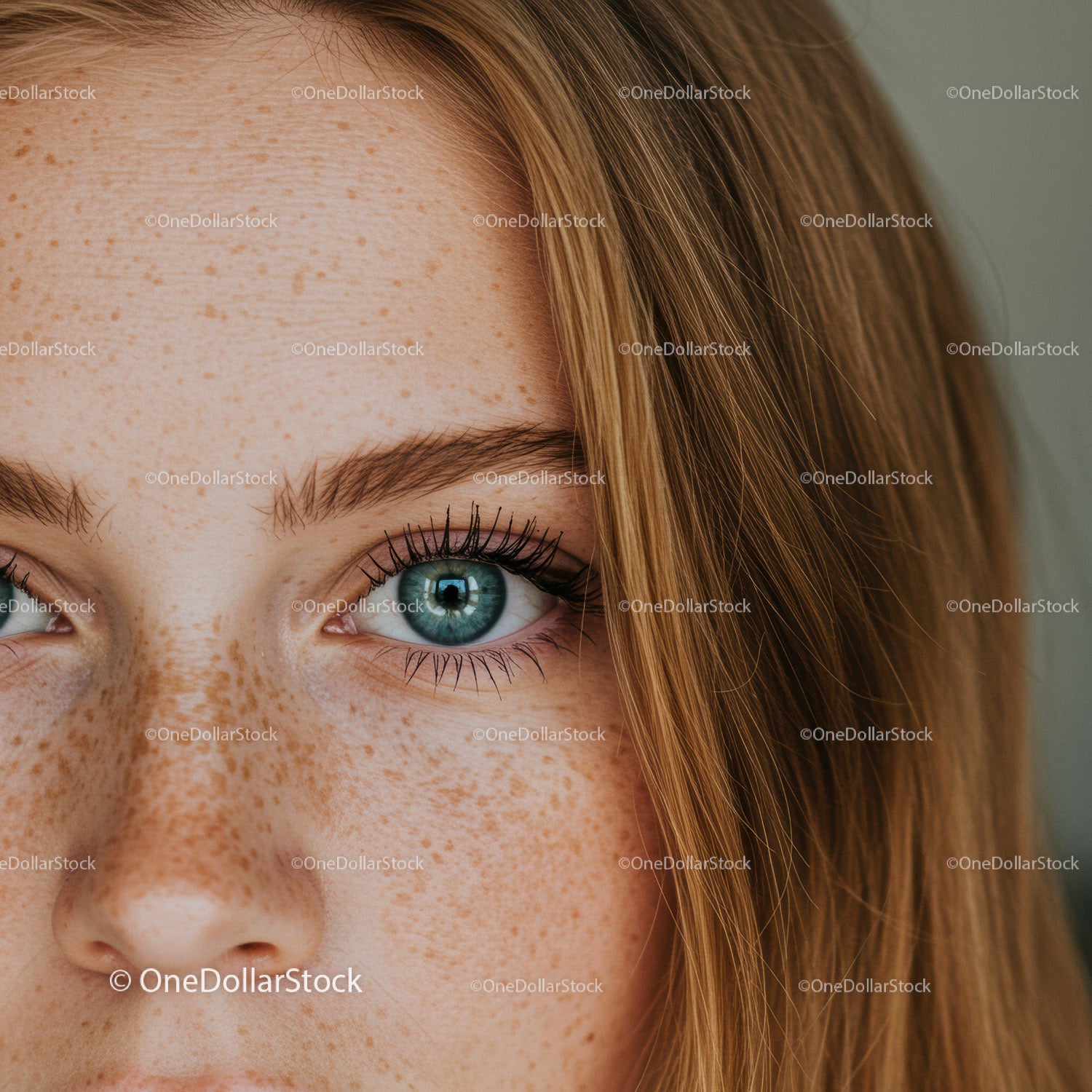 Close-up of freckled blue eye and natural red hair