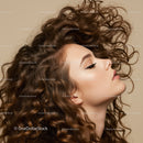 Profile of woman with voluminous curly hair and closed eyes