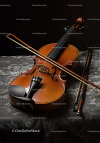 Elegant Wooden Violin with Bow on Dark Textured Surface