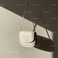 Minimalist white leather handbag hanging on wall