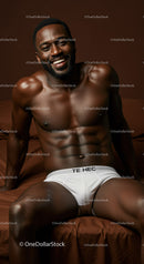 Smiling athletic man relaxing in white briefs on bed