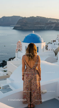 Woman enjoying sunset view over Santorini architecture