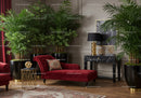 Elegant Red Chaise Lounge Surrounded by Lush Indoor Plants