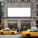 Busy urban street with yellow taxis and blank billboard
