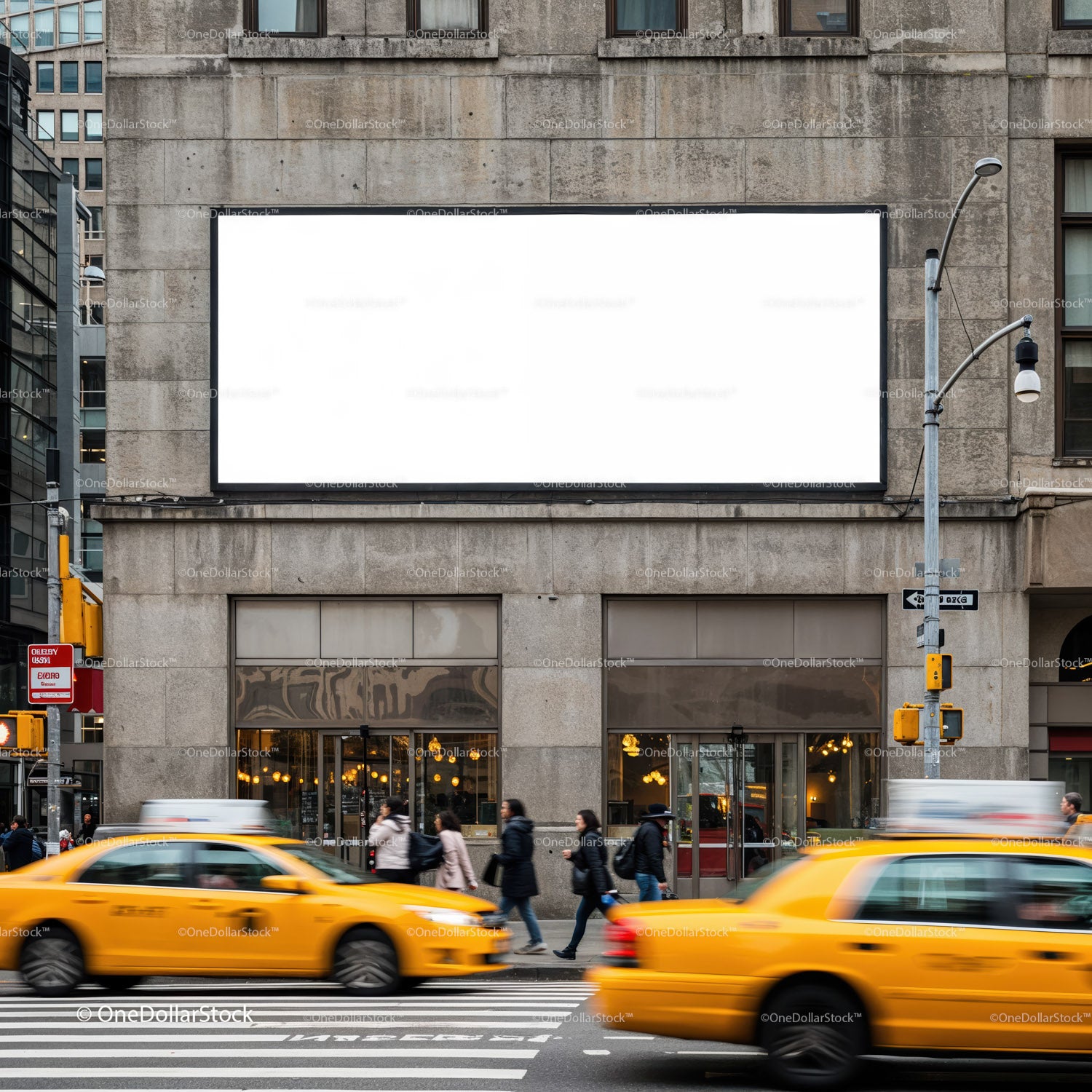 Busy urban street with yellow taxis and blank billboard