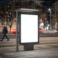Illuminated Blank Billboard on City Sidewalk at Night