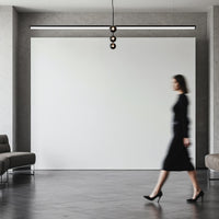 Woman in black dress walking through modern minimal interior