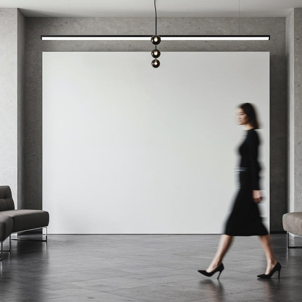 Woman in black dress walking through modern minimal interior JPG Mockup Image