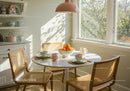 Bright kitchen corner with table set for morning coffee