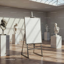Empty easel surrounded by classical sculptures in gallery