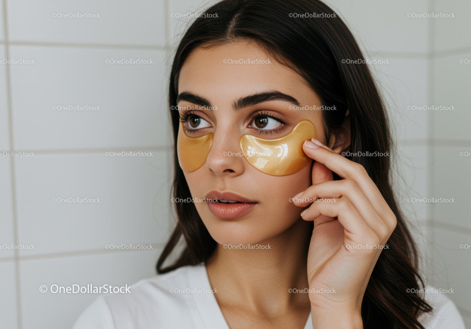 Beautiful Young Woman Applying Gold Collagen Facial Mask