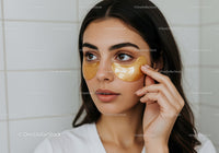 Beautiful Young Woman Applying Gold Collagen Facial Mask
