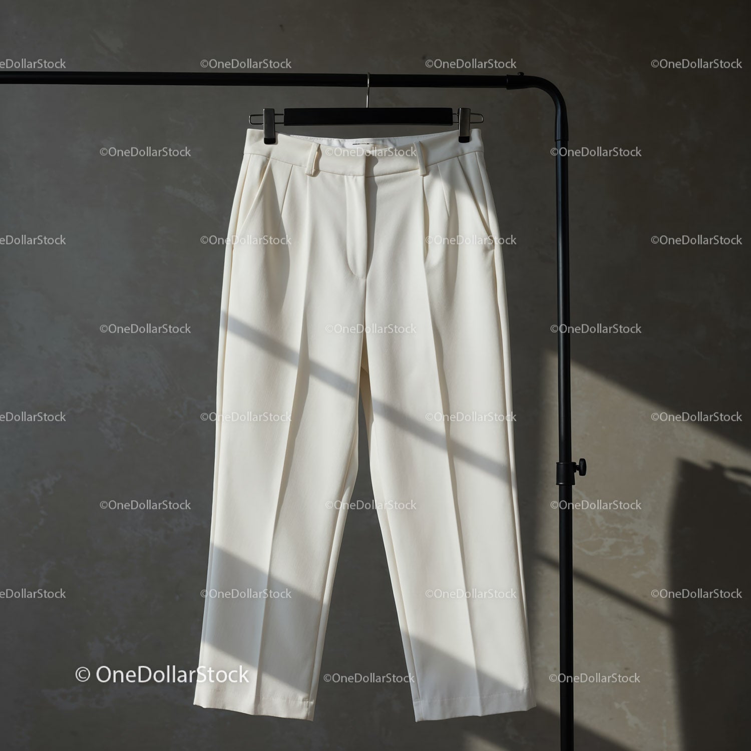 Elegant White Trousers Hanging on Black Rack