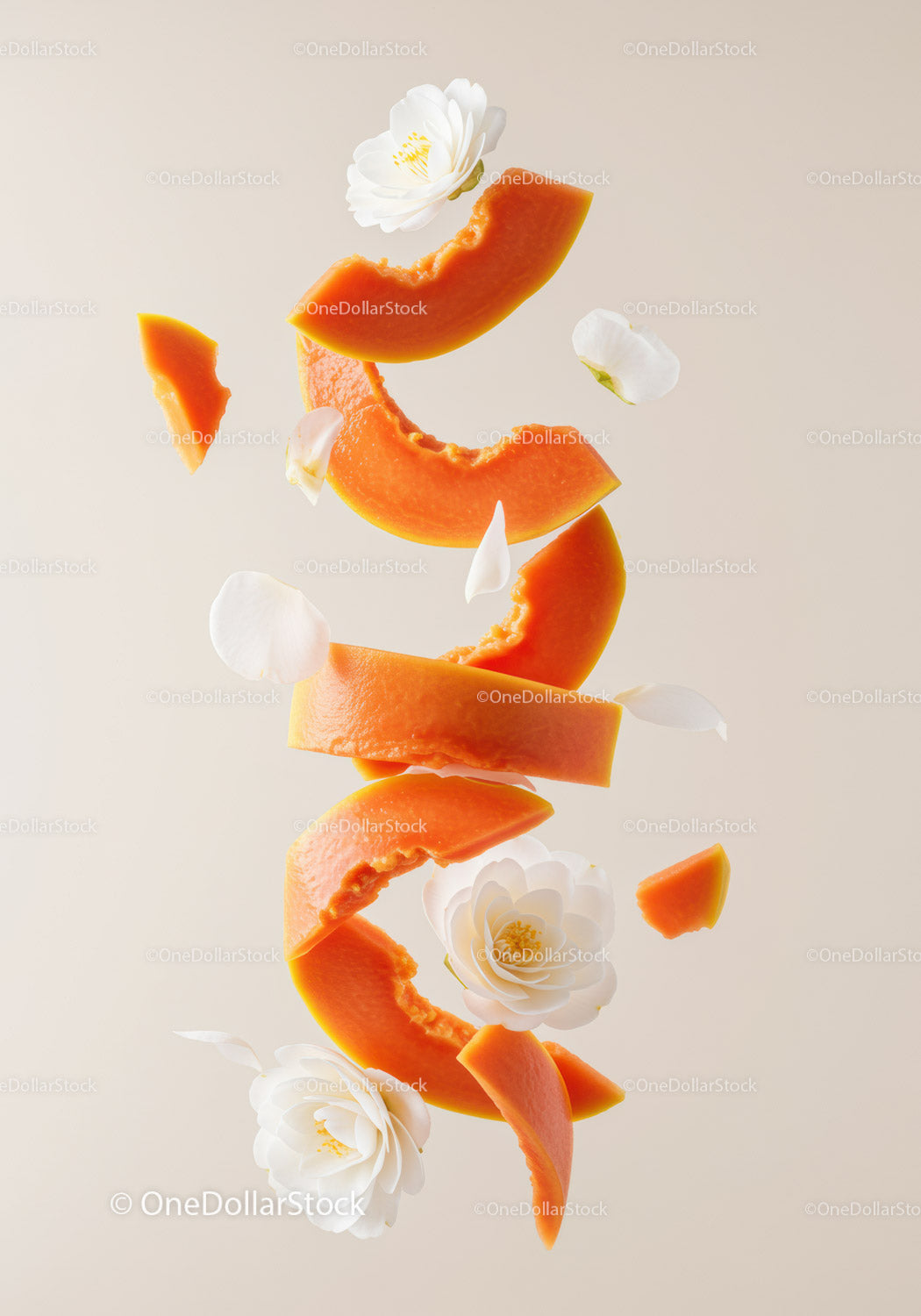 Floating slices of ripe papaya with white flower petals