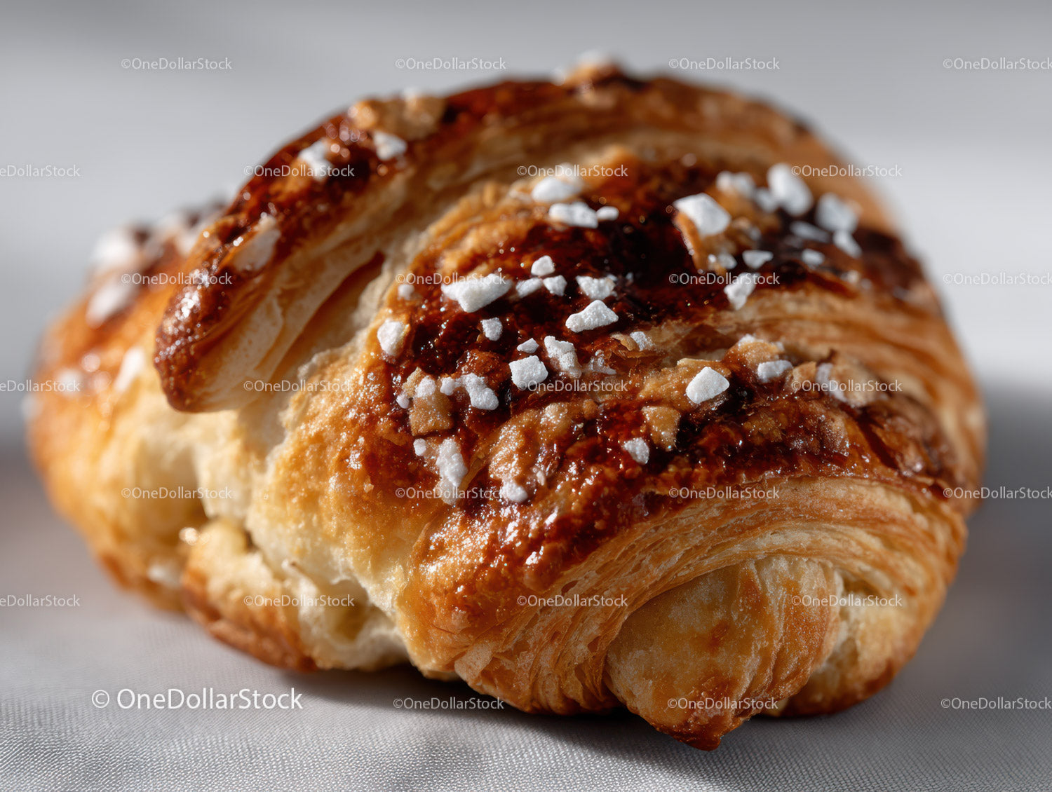 Golden Croissant with Glaze and Powdered Sugar for Breakfast