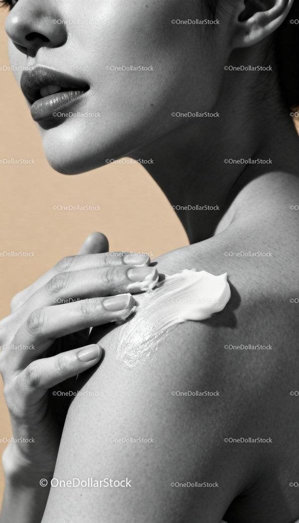 Close up of woman applying cream on shoulder