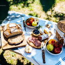Rustic Outdoor Picnic with Bread, Cheese, and Fresh Fruit