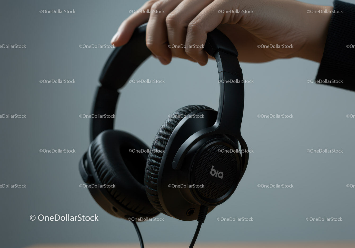 Black Over-Ear Headphones in Hand for Modern Listening Experience