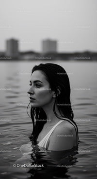 Black and White Portrait of Woman in Water with City Skyline in Background