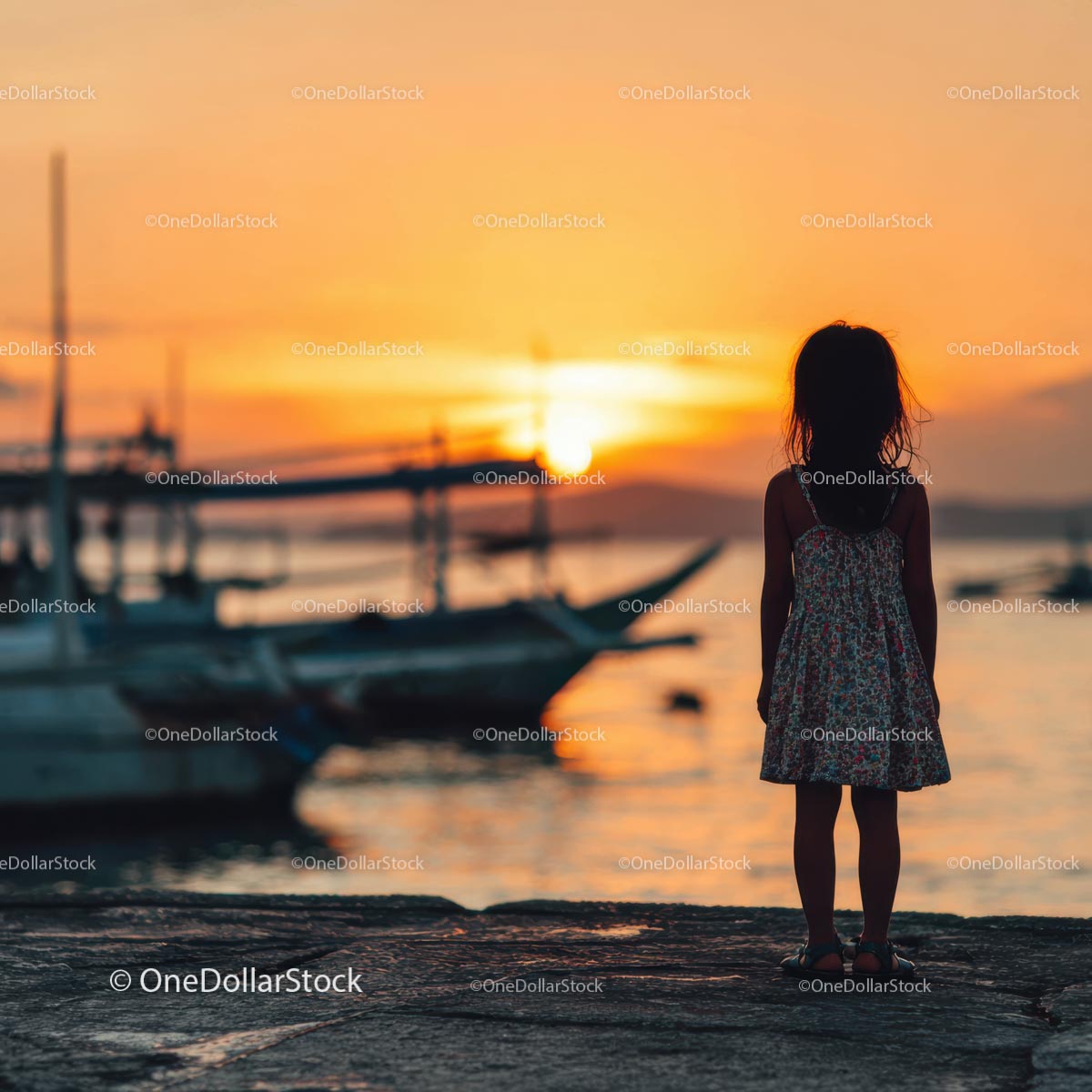 Silhouette of a Child at Sunset by the Ocean Shore
