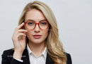 Elegant Woman in Red Glasses and Business Attire in Studio