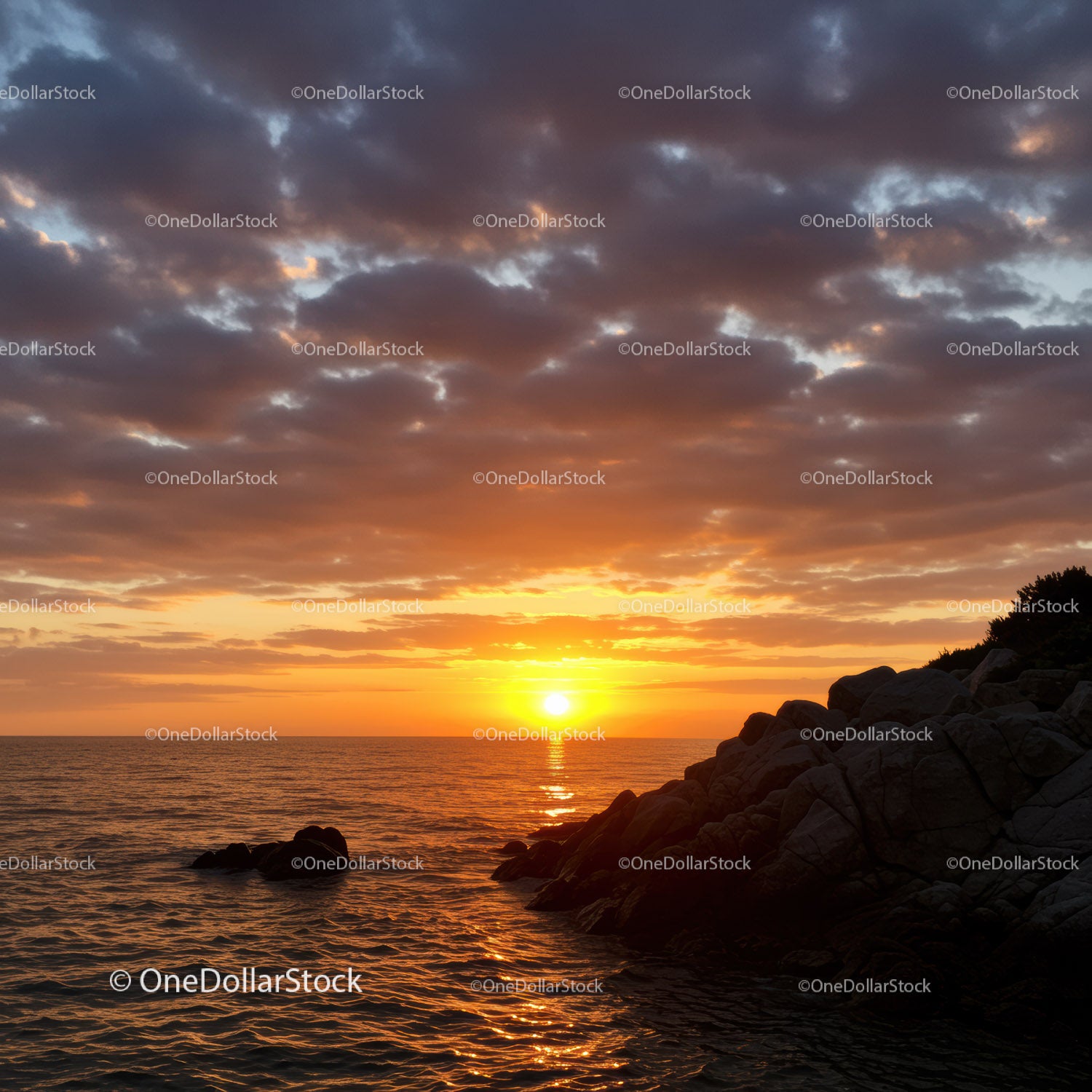 Serene Sunset Over Ocean with Rocky Shore and Vibrant Sky