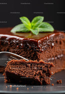 Close Up of Moist Chocolate Cake with Mint Leaf