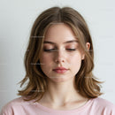 Young Woman with Soft Makeup and Elegant Expression in Studio