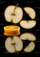 Fresh apple and orange slices with reflections on black