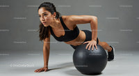 Athletic Woman Performing Plank Exercise with Stability Ball
