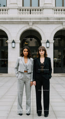 Stylish Businesswomen Standing Confidently in Front of Modern City Building