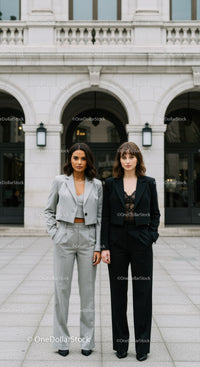 Stylish Businesswomen Standing Confidently in Front of Modern City Building