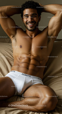 Smiling muscular man relaxing in white briefs on bed