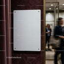 Blank white board on textured office wall