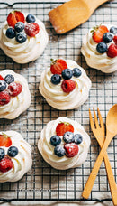 Mini Pavlova Desserts with Fresh Berries on Cooling Rack