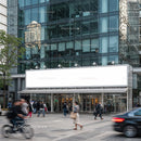 Busy urban street with modern glass office building