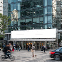 Busy urban street with modern glass office building