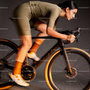 Focused cyclist riding indoor bike in streamlined gear