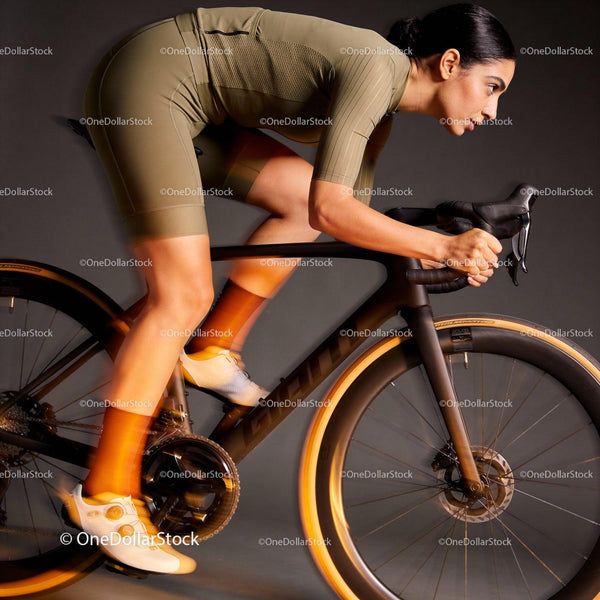 Focused cyclist riding indoor bike in streamlined gear