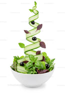 Fresh garden salad with swirling cucumber ribbons and olives