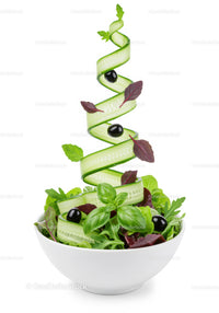 Fresh garden salad with swirling cucumber ribbons and olives