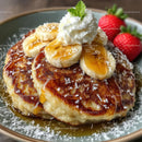 Golden Brown Pancake with Banana Slices Strawberries Whipped Cream