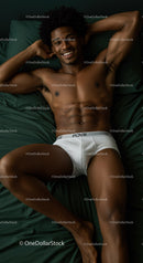 Relaxed young man lying on bed in white underwear