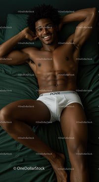 Relaxed young man lying on bed in white underwear