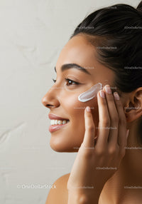 Woman Applying Facial Cream for Healthy Glowing Skin