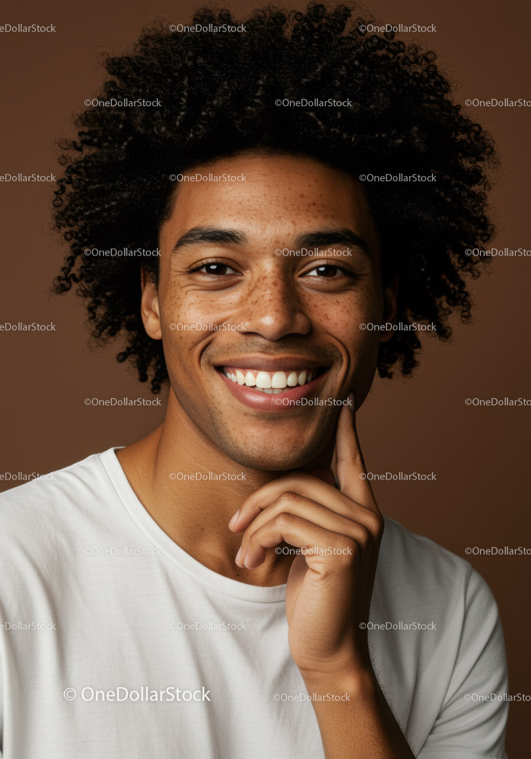 Male Portrait with Bright Smile and Curly Hair in Studio Setting