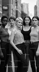 Confident diverse women standing close on urban street