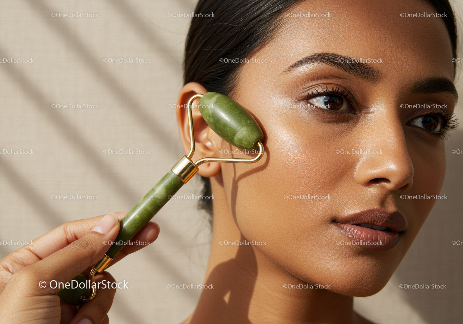 Woman Using Jade Face Roller for Skincare Routine with Natural Glow
