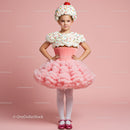 Young girl dressed as a colorful cupcake costume