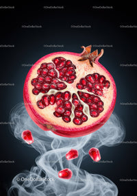 Fresh pomegranate half with juicy seeds and smoke